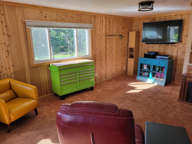 carpeted living room with wood walls and crown molding