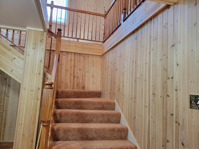 stairs featuring wooden walls