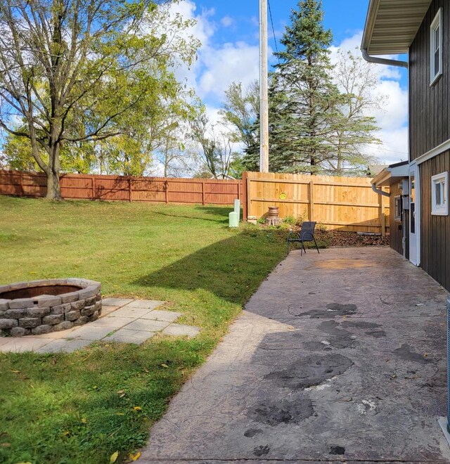 view of yard with a fire pit and a patio area