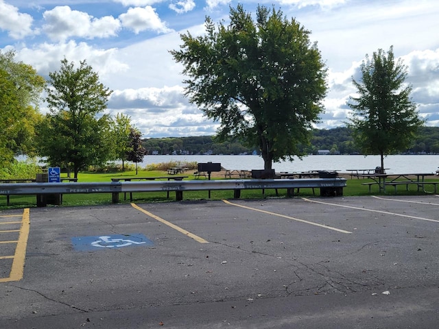 view of vehicle parking with a water view