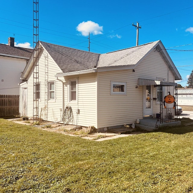 back of property featuring a yard