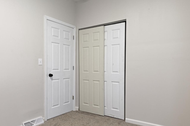 interior space featuring carpet flooring and a closet