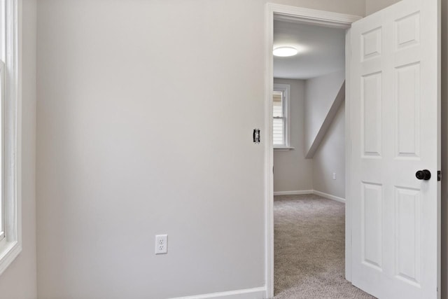 hall featuring light carpet