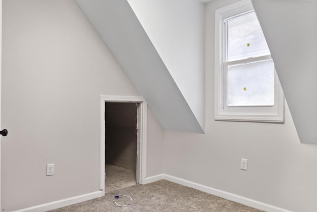 additional living space featuring lofted ceiling, light carpet, and a wealth of natural light