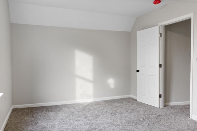 interior space featuring lofted ceiling and carpet flooring