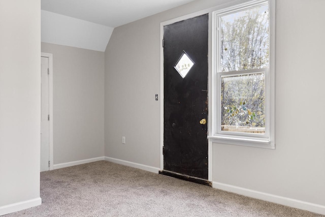 entryway featuring light carpet and lofted ceiling