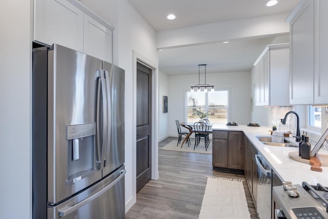 1295 Stonehaven Dr, Sun Prairie, WI 53590 - kitchen featuring light wood-type flooring, recessed lighting, appliances with stainless steel finishes, light countertops, and a sink