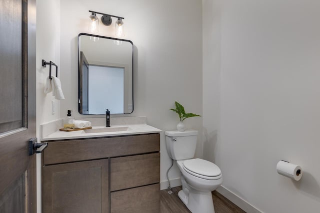 1295 Stonehaven Dr, Sun Prairie, WI 53590 - bathroom featuring vanity, baseboards, toilet, and wood finished floors