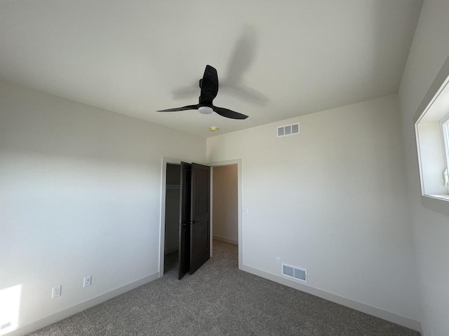 unfurnished bedroom with ceiling fan and carpet floors