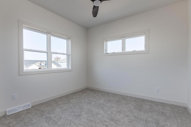 1295 Stonehaven Dr, Sun Prairie, WI 53590 - spare room featuring light carpet, visible vents, baseboards, and ceiling fan