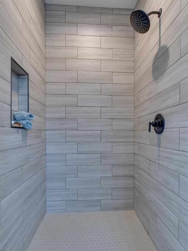 bathroom with tiled shower