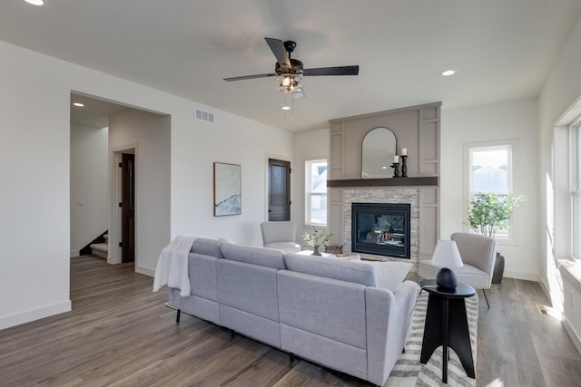 1295 Stonehaven Dr, Sun Prairie, WI 53590 - living area with visible vents, baseboards, a ceiling fan, a fireplace, and wood finished floors