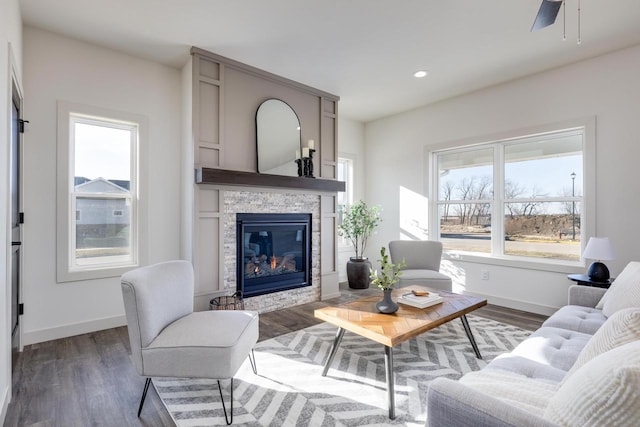 1295 Stonehaven Dr, Sun Prairie, WI 53590 - living room with baseboards, wood finished floors, and a glass covered fireplace