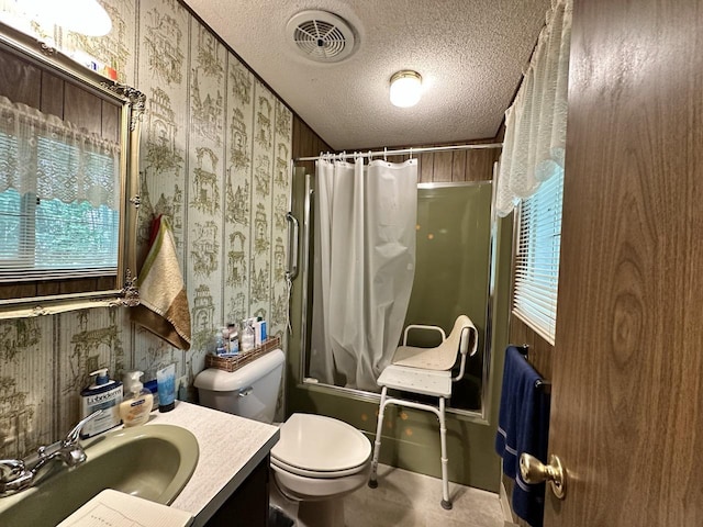 full bathroom with vanity, a textured ceiling, toilet, and shower / bathtub combination with curtain