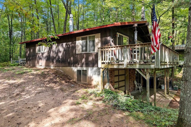 back of house with a wooden deck