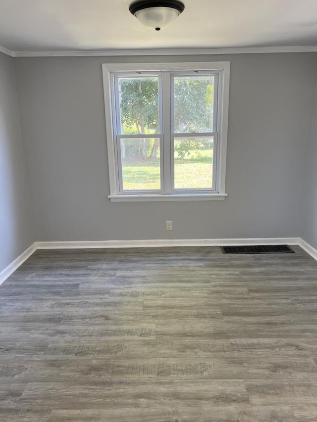 unfurnished room with crown molding and hardwood / wood-style floors