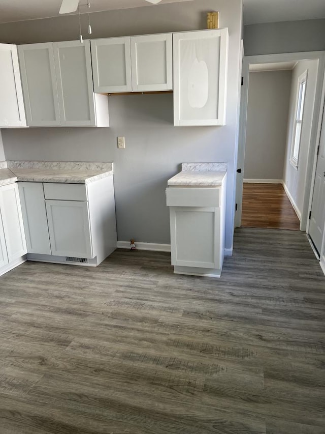 kitchen with white cabinets, ceiling fan, and dark hardwood / wood-style floors