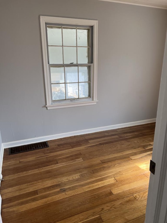 unfurnished room with dark hardwood / wood-style flooring