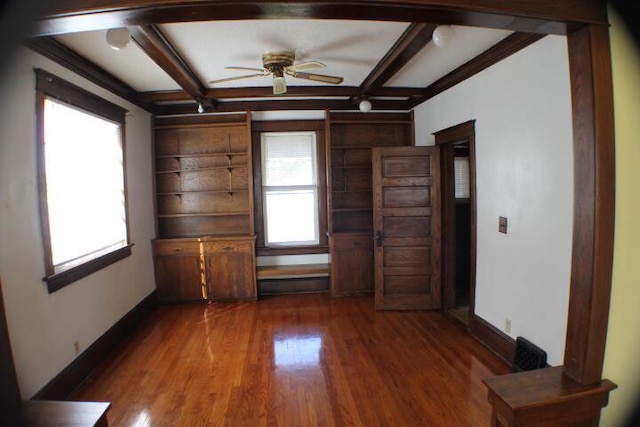 unfurnished bedroom with coffered ceiling, beamed ceiling, and dark wood-type flooring