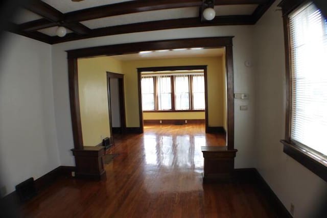 hallway with beamed ceiling and hardwood / wood-style flooring