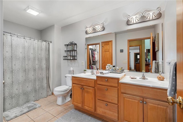 bathroom featuring curtained shower, vanity, toilet, and tile patterned floors