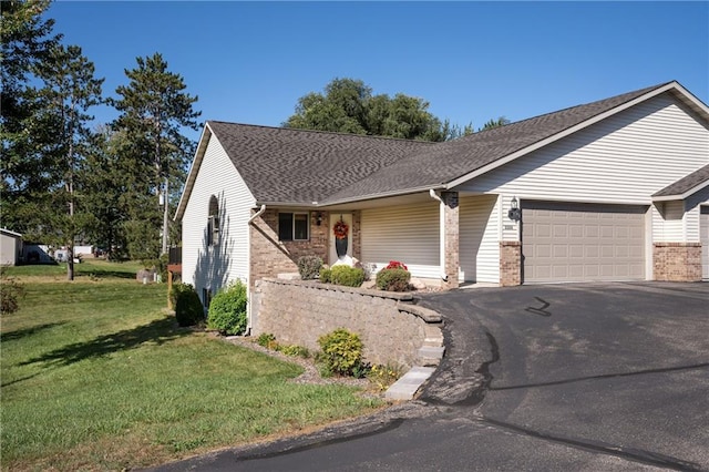 ranch-style house featuring a garage and a front lawn