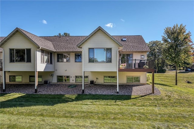 rear view of property featuring a yard and central AC