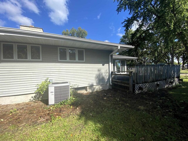 view of home's exterior with a deck and central AC