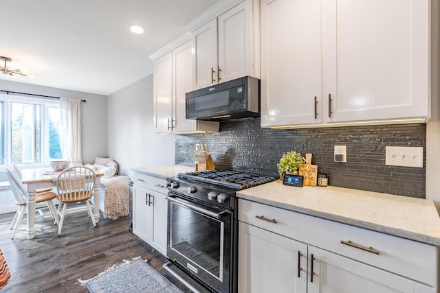 kitchen with range with gas stovetop, white cabinetry, decorative backsplash, and dark wood-type flooring