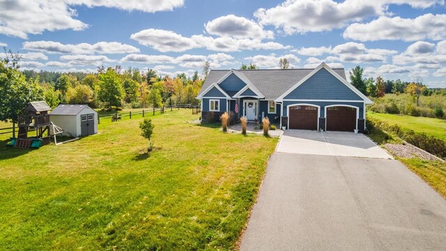 view of front of house featuring a storage shed and a front lawn