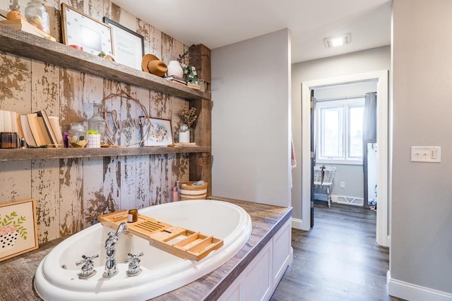 bathroom featuring hardwood / wood-style flooring and a bathing tub