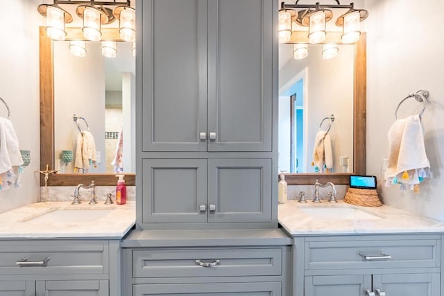 bathroom featuring vanity and a notable chandelier