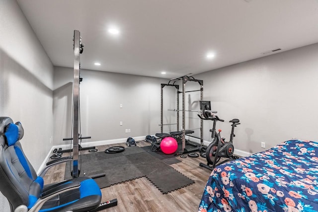 workout room with light hardwood / wood-style floors