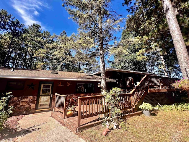 ranch-style house featuring a wooden deck