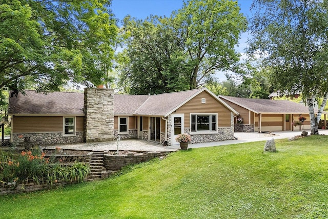 rear view of house featuring a patio and a yard