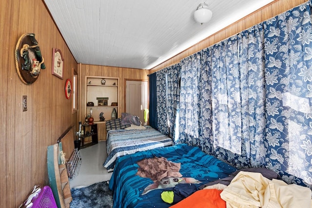 bedroom featuring wooden walls