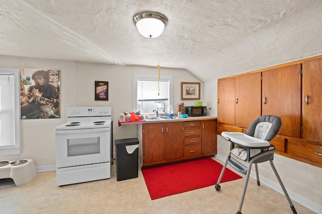 kitchen featuring lofted ceiling, electric stove, a textured ceiling, and sink