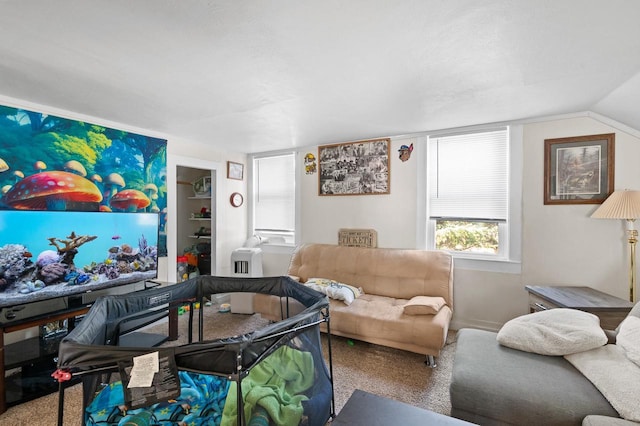 carpeted living room featuring vaulted ceiling