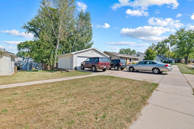 view of yard featuring a garage and an outbuilding