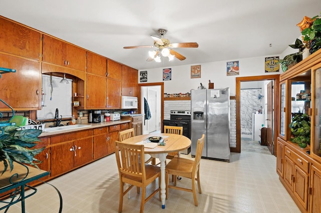 kitchen featuring sink, ceiling fan, and stainless steel appliances