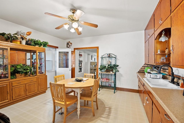 dining area with sink and ceiling fan