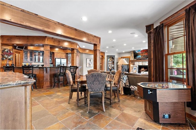 dining room featuring a stone fireplace