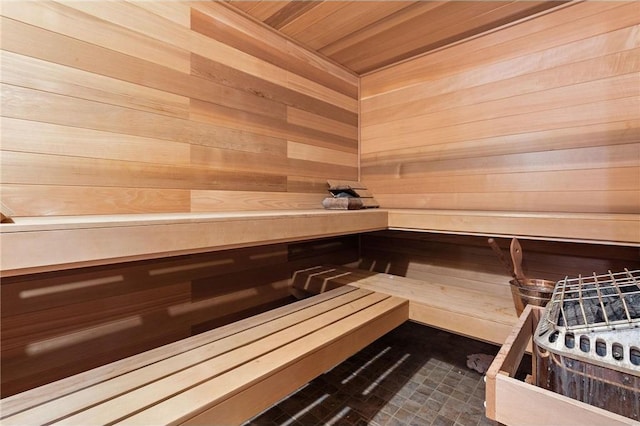 view of sauna with wooden walls and wood ceiling