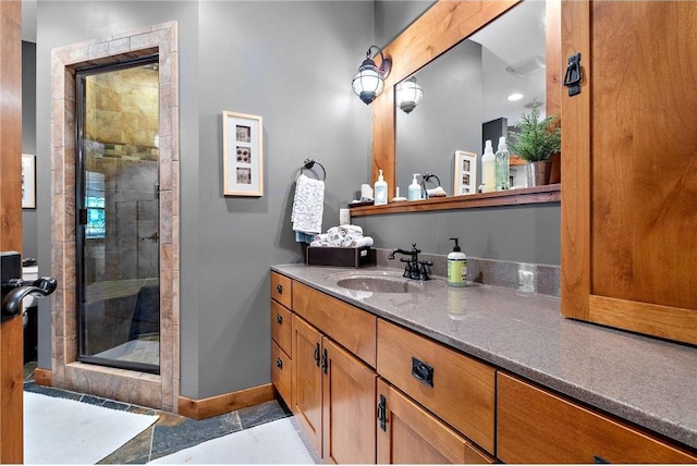 bathroom featuring tile patterned flooring, vanity, and a shower with door