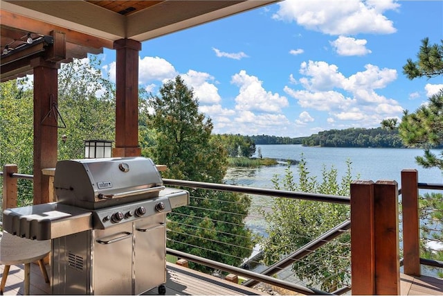 balcony featuring a water view and area for grilling