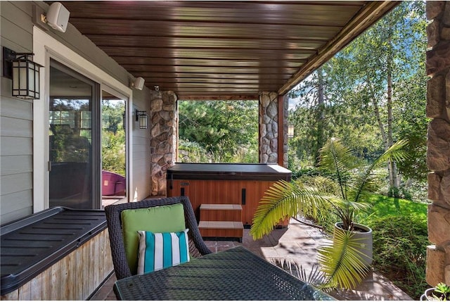 wooden deck featuring a patio area and a hot tub