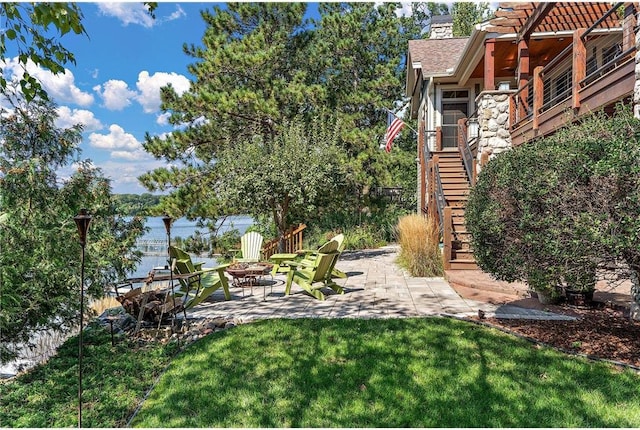 view of yard featuring a patio and a fire pit