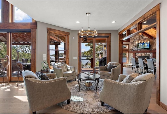 living room featuring a fireplace, a chandelier, and a wealth of natural light