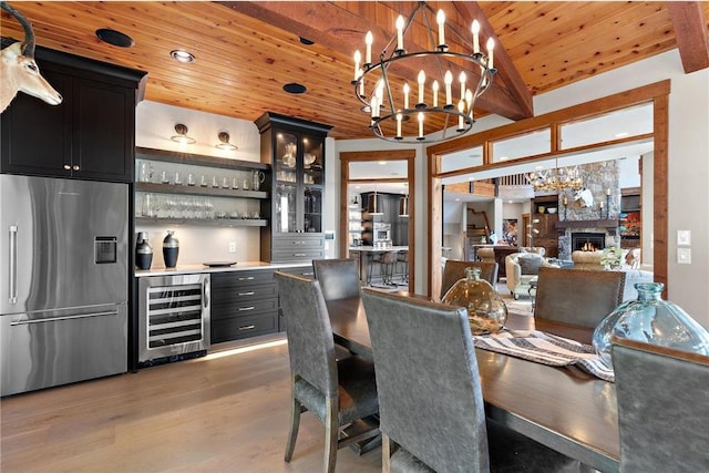 dining room featuring wine cooler, wooden ceiling, light wood-type flooring, an inviting chandelier, and bar area