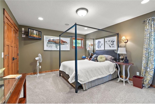 carpeted bedroom with a textured ceiling